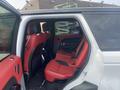 Interior view of a 2020 Land Rover Range Rover Sport featuring red leather seats in the rear cabin