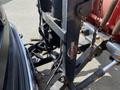 Close-up view of a hitch mounted on a 2010 Ford F-550 showing the Ultra Mount label with visible chains and mechanical components attached