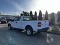 A white 2008 Ford F-150 XL pickup truck parked with a regular cab and long bed