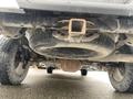 Undercarriage view of a 2017 Ford F-150 showing the spare tire under the bed and the rear axle with visible wear and dirt