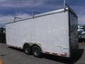 A white 2010 Forest River enclosed trailer with a flat roof and dual wheels on each side