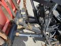 Close-up of the hydraulic system and components of a 2010 Ford F-550 showing linkage arms and hydraulic cylinders