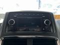 Dashboard of a 2011 Dodge Grand Caravan featuring a radio display with buttons and knobs for controlling volume and tuning