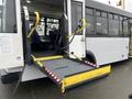 A 2018 Chevrolet Express with a lowered wheelchair ramp and open rear doors revealing interior seating