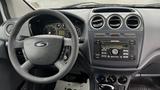 Interior view of a 2012 Ford Transit featuring a steering wheel gauges and dashboard controls