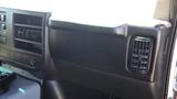 Interior dashboard of a 2012 GMC Savana showing a black plastic panel with air vents and dashboard controls