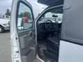 A 2017 Chevrolet Express with its driver's side door open showcasing the interior including the dashboard and front seats