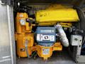 A yellow and orange diesel pump with a digital display and pressure gauge mounted on a vehicle