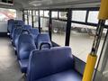 Interior view of a 2018 Chevrolet Express with blue fabric seats arranged in a row facing forward