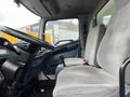 Interior view of a 2008 Hino Conventional Cab showing two gray seats and the steering wheel from the driver's perspective