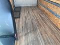 A 2017 Mercedes-Benz Sprinter van interior with wooden flooring and a metal grate on one side