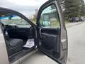 A 2013 Chevrolet Silverado Hybrid with an open driver's side door showcasing the interior and dashboard details