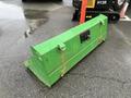 A green metal box attachment for a John Deere 790 tractor with a lock and two latches on the front