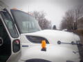 A white 2008 International 7400 truck with a prominent hood and amber light on top of the cab