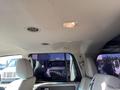 Interior view of a 2013 Ford Expedition showing the ceiling with light fixtures and air vents along with two front seats in light upholstery