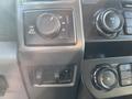 Control panel of a 2019 Ford F-350 SD featuring knobs for drive settings and volume along with a button for additional functions