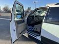 A 2013 Ford Expedition with an open door revealing a beige interior and steering wheel