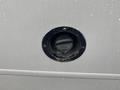 Fuel cap on a 2018 Chevrolet Express van with a round black opening and a circular metallic border