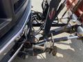 Close-up view of the hitch and towing apparatus of a 2010 Ford F-550 showing the connection points and mechanical components