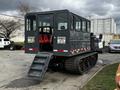 2023 Prinoth Panther T6 tracked vehicle with a cabin featuring large windows and a back entrance with steps customizable seating inside