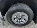 A close-up of a chrome wheel with a Hankook tire on a 2017 GMC Sierra 1500 showcasing the tread pattern and shiny finish