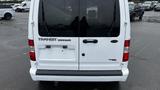 White 2012 Ford Transit Connect van viewed from the rear with a large back window and no visible license plate