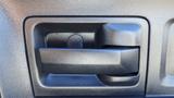 A black door handle on a vehicle interior