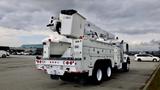 A 2008 International 7500 truck equipped with an Altec aerial lift and utility body shown from the rear with a raised boom and empty cargo area