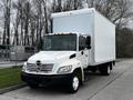 A white 2006 Hino 268 box truck with a large cargo area and front grille displaying the Hino logo