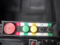 Control panel of a 2008 International 7400 with red green and yellow buttons and knobs labeled for operation