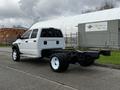 A white 2008 Dodge Ram 5500 chassis cab with a long bed and dual rear wheels parked on a concrete surface