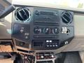Interior dashboard of a 2010 Ford F-550 featuring controls for audio climate and various switches