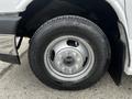 Close-up of a silver wheel with a multi-spoke rim and tire of a 2017 Chevrolet Express