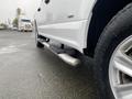 A white 2017 Ford F-150 with a chrome running board and a close-up view of its tire and wheel