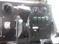 Close-up of the gear shifter and control panel of a 2007 Morgan Olson Workhorse W42 featuring various switches and knobs for vehicle operation