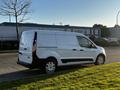 A white 2022 Ford Transit Connect van parked with side profile visible showcasing sliding side door and distinctive shape