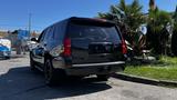 A black 2018 Chevrolet Tahoe parked with its rear facing the viewer showcasing its sleek design and tinted windows