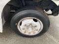 A close-up of a wheel from a 2005 Freightliner MT45 chassis featuring a silver rim and a black tire with visible tread and wheel lug nuts