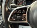Close-up of the steering wheel controls of a 2019 Mercedes-Benz Sprinter featuring buttons for cruise control and functions like set and cancel
