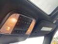 Interior ceiling controls of a 2018 Jeep Grand Cherokee featuring lights and various adjustment buttons