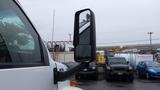 A 2008 Chevrolet C7500 with a black side mirror prominently displayed in the foreground