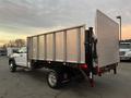 A white 2008 Dodge Ram 5500 flatbed truck with a metal cargo area and a raised rear loading gate