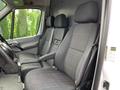 The image shows the front seats of a 2017 Mercedes-Benz Sprinter with two black fabric-covered seats and a steering wheel visible