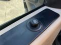 Close-up of the control knob for the power window on the driver side of a 2013 Ford F-450 SD