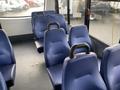 Interior view of a 2018 Chevrolet Express showing blue vinyl seats arranged in rows with headrests and armrests