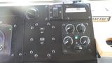 Dashboard controls of a 2005 Morgan Olson Workhorse with various switches knobs and gauges for operational settings