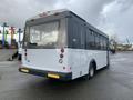 2018 Chevrolet Express bus with a white and black exterior featuring large windows and rear lights