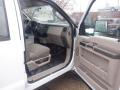 Interior view of a 2009 Ford F-450 SD with a tan cloth seat and dashboard showing controls and features of the vehicle