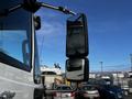 A side mirror of a 2013 International DuraStar 4300 truck reflecting the surroundings