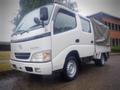 A white 2003 Toyota Toyoace truck with a covered cargo area and a clean design